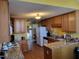 Traditional kitchen featuring wooden cabinets, granite countertops, and modern appliances at 1317 Justin Oaks Ct, Willow Springs, NC 27592