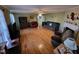 Spacious living room with hardwood floors, a ceiling fan, and lots of comfortable seating at 1317 Justin Oaks Ct, Willow Springs, NC 27592
