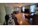 Open living room with hardwood floors, fireplace, large window, and cozy seating at 1317 Justin Oaks Ct, Willow Springs, NC 27592