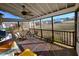 Screened-in porch featuring wood flooring, fan, and outdoor seating area at 1317 Justin Oaks Ct, Willow Springs, NC 27592