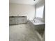 Bathroom featuring a soaking tub, double vanity sinks, and modern fixtures, offering a luxurious bathing experience at 1663 Keith Hills Rd, Lillington, NC 27546