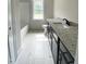A new bathroom with granite countertop and tile floors at 1663 Keith Hills Rd, Lillington, NC 27546