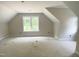 A new bedroom with vaulted ceilings and a large window at 1663 Keith Hills Rd, Lillington, NC 27546