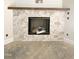 Close-up of a stylish fireplace featuring a marble surround and a wooden mantel at 1663 Keith Hills Rd, Lillington, NC 27546