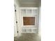 Hallway showing built-in shelving unit with wood accent panel, offering decorative storage space at 1663 Keith Hills Rd, Lillington, NC 27546