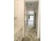 Hallway featuring white trim, leading to a room with tray ceiling and large windows for natural light at 1663 Keith Hills Rd, Lillington, NC 27546