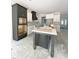 Spacious kitchen featuring a dark island, white cabinets, and stainless steel appliances at 1663 Keith Hills Rd, Lillington, NC 27546