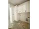 Bright laundry room with white cabinets, offering ample storage, and utility connections at 1663 Keith Hills Rd, Lillington, NC 27546