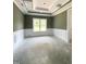 A bright room with green walls, white trim and a decorative tray ceiling and large window at 1663 Keith Hills Rd, Lillington, NC 27546