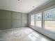 Room featuring modern accent wall and a trio of windows, offering plenty of natural light at 1663 Keith Hills Rd, Lillington, NC 27546