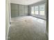 Room featuring modern accent wall and a trio of windows, offering plenty of natural light at 1663 Keith Hills Rd, Lillington, NC 27546