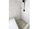 Close-up of a shower with decorative tile and glass shelving with modern fixture at 1663 Keith Hills Rd, Lillington, NC 27546
