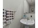 Half bathroom featuring a pedestal sink, a decorative mirror, and colorful towels at 17 Donatella Way, Angier, NC 27501