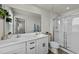 Bright bathroom with double vanity sinks, a large mirror, and a glass-door shower at 17 Donatella Way, Angier, NC 27501