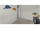 Neutral bedroom with dinosaur wall decor and a side table with plant accent at 17 Donatella Way, Angier, NC 27501