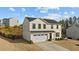Two-story house with a two car garage, a yard, and well-manicured front landscaping at 17 Donatella Way, Angier, NC 27501