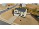 Two-story home featuring a two car garage and a well-maintained lawn in a suburban neighborhood at 17 Donatella Way, Angier, NC 27501