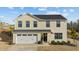 Charming two-story home with a well-manicured lawn, attached garage and welcoming front porch at 17 Donatella Way, Angier, NC 27501