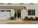 Close up of the front door with a welcoming wreath and an American flag adding a patriotic touch at 17 Donatella Way, Angier, NC 27501