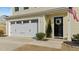 Attached garage with a white door complemented by a manicured lawn, adding curb appeal to the home at 17 Donatella Way, Angier, NC 27501