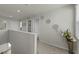 Upstairs hallway featuring multiple doors, natural lighting, and decorative vases at 17 Donatella Way, Angier, NC 27501