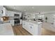 Open concept kitchen with island and stainless steel appliances connected to the living room at 17 Donatella Way, Angier, NC 27501