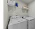 Bright laundry room with white appliances and shelving at 17 Donatella Way, Angier, NC 27501