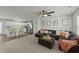 Spacious living room with plush seating and a cozy atmosphere, adjacent to an open-concept kitchen at 17 Donatella Way, Angier, NC 27501