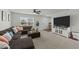 Comfortable living room showcasing ample seating, a large window and entertainment center at 17 Donatella Way, Angier, NC 27501
