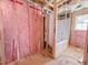 Unfinished bathroom showing plumbing, bathtub insert, and pink insulation within the wood framing at 1905 Old Bramble Ln # 4, Fuquay Varina, NC 27526