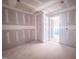 Bedroom featuring drywall ready for finishes, an open doorway and natural light in an unfinished new home at 1905 Old Bramble Ln # 4, Fuquay Varina, NC 27526