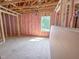 Framed bedroom with pink insulation, framing, and a view of the window at 1905 Old Bramble Ln # 4, Fuquay Varina, NC 27526