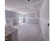 Spacious living room with drywall ready for finishes, large windows, and natural light in an unfinished new home at 1905 Old Bramble Ln # 4, Fuquay Varina, NC 27526