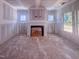 Unfinished living room showcasing a fireplace and natural light from windows, awaiting final finishing touches at 1905 Old Bramble Ln # 4, Fuquay Varina, NC 27526