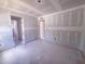 A well-lit living room with multiple entryways and a neutral color palette at 1905 Old Bramble Ln # 4, Fuquay Varina, NC 27526
