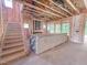 Unfinished living room with staircase showcasing exposed beams and natural light at 1905 Old Bramble Ln # 4, Fuquay Varina, NC 27526