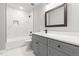 Bright bathroom with white marble tile and grey vanity at 200 Single Tree Cir, Haw River, NC 27258