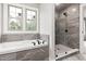 Bright bathroom showcasing a soaking tub and glass enclosed shower at 200 Single Tree Cir, Haw River, NC 27258