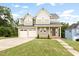 Charming two-story home with attached two-car garage and well-manicured lawn at 200 Single Tree Cir, Haw River, NC 27258