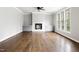 Bright and airy living room with hardwood floors, a fireplace, and a window providing natural light at 200 Single Tree Cir, Haw River, NC 27258