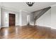 Open-concept living space featuring hardwood floors and staircase with wrought iron railing at 200 Single Tree Cir, Haw River, NC 27258