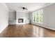 Spacious living room with a fireplace, hardwood floors, and ample natural light from large windows at 200 Single Tree Cir, Haw River, NC 27258