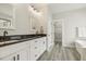 Modern bathroom with double vanity, granite countertops, and a walk-in closet at 212 Lynch Ave, Lillington, NC 27546