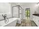 Bright bathroom featuring a soaking tub, a glass-enclosed shower, and modern fixtures at 212 Lynch Ave, Lillington, NC 27546