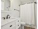 A full bath with a large vanity, a white counter, and a shower with curtain at 212 Lynch Ave, Lillington, NC 27546