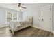 A bedroom featuring a ceiling fan, a large window, and hardwood floors at 212 Lynch Ave, Lillington, NC 27546