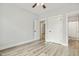 A bedroom featuring neutral walls, a ceiling fan, and durable gray flooring at 212 Lynch Ave, Lillington, NC 27546