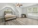 An upstairs bedroom with hardwood floors, a ceiling fan, and plenty of space at 212 Lynch Ave, Lillington, NC 27546