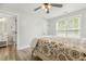 A bedroom with hardwood flooring, a ceiling fan, and access to a bathroom at 212 Lynch Ave, Lillington, NC 27546