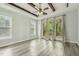 Bright bedroom with wood beams, large windows, and access to a balcony with outdoor views at 212 Lynch Ave, Lillington, NC 27546